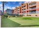 Exterior shot featuring artificial turf, lush hedges and multi-story apartments at 51 E Agate Ave # 506, Las Vegas, NV 89123