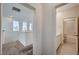 Hallway leading to a full bathroom with bathtub, shower and vanity at 513 Founders Creek Ave, North Las Vegas, NV 89084