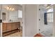 Bathroom with vanity, and door leading to the bedroom with ceiling fan at 540 Viva Serenade Way, Henderson, NV 89015