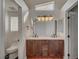 Bright bathroom with a double sink vanity, wood cabinets, and a window for natural light at 540 Viva Serenade Way, Henderson, NV 89015
