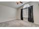 Bright bedroom featuring a vaulted ceiling, ceiling fan, and large window at 540 Viva Serenade Way, Henderson, NV 89015