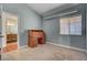 Bright bedroom with a wood desk and ample natural light coming through the large window at 540 Viva Serenade Way, Henderson, NV 89015