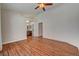 Large bedroom with hardwood floors, ceiling fan, and a view into the attached bathroom at 540 Viva Serenade Way, Henderson, NV 89015