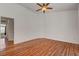 Large, empty bedroom with hardwood floors, a ceiling fan, and a view into an adjacent room at 540 Viva Serenade Way, Henderson, NV 89015