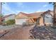 Single story home with terra cotta roof featuring desert landscaping, rock accents, and a two car garage at 540 Viva Serenade Way, Henderson, NV 89015