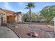 Single story home with terra cotta roof, desert landscaping with decorative rock and a two car garage at 540 Viva Serenade Way, Henderson, NV 89015