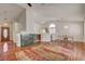 Open-concept living area with hardwood floors, a marble fireplace and a wooden door with glass accents at 540 Viva Serenade Way, Henderson, NV 89015