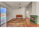 Open concept living area with hardwood floors, a fireplace and a glass sliding door leading to the pool at 540 Viva Serenade Way, Henderson, NV 89015