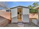 Open door to backyard shed revealing a clean interior and an additional storage space at 540 Viva Serenade Way, Henderson, NV 89015