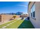 Charming backyard featuring artificial grass, a firepit, and privacy walls at 5648 Vermillion Ridge St, North Las Vegas, NV 89031