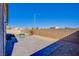 Backyard features a paved patio area, gravel accents, and a cozy fire pit at 5648 Vermillion Ridge St, North Las Vegas, NV 89031