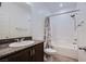 Neutral bathroom featuring a shower-tub combo with tiled walls, a sink with a granite countertop, and modern fixtures at 5648 Vermillion Ridge St, North Las Vegas, NV 89031