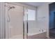 Bright bathroom features a shower and soaking tub with lots of natural light at 5648 Vermillion Ridge St, North Las Vegas, NV 89031
