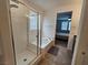 Bright bathroom featuring a shower-tub combo and views into the bedroom at 5648 Vermillion Ridge St, North Las Vegas, NV 89031