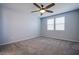 Bright and airy bedroom featuring carpet, a ceiling fan, and large windows that let in natural light at 5648 Vermillion Ridge St, North Las Vegas, NV 89031