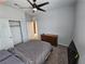 Bedroom with dark ceiling fan, neutral walls, carpet floors, dresser, closet, and queen bed at 5648 Vermillion Ridge St, North Las Vegas, NV 89031