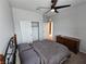 Bedroom with a dark ceiling fan, neutral walls, carpet floors, dresser, closet, and queen bed at 5648 Vermillion Ridge St, North Las Vegas, NV 89031