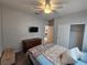 Comfortable bedroom with ceiling fan, TV, dresser, closet, and neutral color palette at 5648 Vermillion Ridge St, North Las Vegas, NV 89031