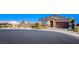 Beautiful single-story home with a two-car garage and well-manicured landscaping on a sunny day at 5648 Vermillion Ridge St, North Las Vegas, NV 89031