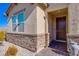 Inviting front entrance with stone accents and a private property sign at 5648 Vermillion Ridge St, North Las Vegas, NV 89031
