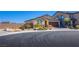 Inviting one-story home with stone details, two-car garage, and a low-maintenance desert front yard at 5648 Vermillion Ridge St, North Las Vegas, NV 89031
