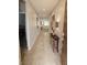 Inviting hallway with neutral tile flooring leads to an open living area, showcasing a stylish console table and decor at 5648 Vermillion Ridge St, North Las Vegas, NV 89031