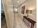 Inviting hallway with neutral tile flooring and a view to open living area, showcasing a stylish console table and decor at 5648 Vermillion Ridge St, North Las Vegas, NV 89031