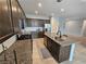 Beautiful kitchen with dark wood cabinets, granite countertops, and stainless steel appliances at 5648 Vermillion Ridge St, North Las Vegas, NV 89031