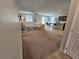 Open-concept living room with carpet floors, lots of light, and view to the kitchen and dining area at 5648 Vermillion Ridge St, North Las Vegas, NV 89031