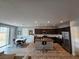 Open concept living area featuring a modern kitchen with stainless steel appliances and a dining area at 5648 Vermillion Ridge St, North Las Vegas, NV 89031
