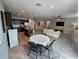 Bright living room with an open floor plan, kitchen with island, and adjacent dining area at 5648 Vermillion Ridge St, North Las Vegas, NV 89031