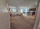 Open-concept living room with carpet floors, lots of light, and view to the kitchen and dining area at 5648 Vermillion Ridge St, North Las Vegas, NV 89031