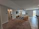 Inviting living room with neutral carpet, ceiling fan, large window, and sliding glass doors at 5648 Vermillion Ridge St, North Las Vegas, NV 89031