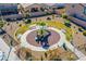 Aerial view of a neighborhood playground with a green play structure and benches at 5648 Vermillion Ridge St, North Las Vegas, NV 89031