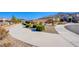 Scenic view of neighborhood sidewalk lined with mature trees and lush landscaping at 5648 Vermillion Ridge St, North Las Vegas, NV 89031