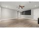 Open-concept living room with wood-look flooring, neutral paint, and recessed lighting exudes modern charm at 5662 Tingley Ave, Las Vegas, NV 89141