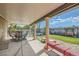 This covered back patio overlooks a green yard with plenty of space for outdoor entertaining at 5775 W Desert Inn Rd, Las Vegas, NV 89146