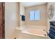 Neutral bathroom with a large soaking tub, bright lighting, and vanity space at 5775 W Desert Inn Rd, Las Vegas, NV 89146