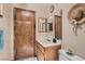 Modest bathroom featuring a neutral wall color, wood cabinets, and standard fixtures at 5775 W Desert Inn Rd, Las Vegas, NV 89146