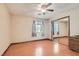 This bedroom features wood floors, a ceiling fan, a window and a sliding closet at 5775 W Desert Inn Rd, Las Vegas, NV 89146