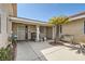 Inviting home entrance with a decorative security door, a charming bench, and a mature palm tree at 5775 W Desert Inn Rd, Las Vegas, NV 89146