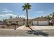 Charming single-story home with a well-manicured lawn, a palm tree, and a two-car garage at 5775 W Desert Inn Rd, Las Vegas, NV 89146