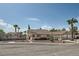 Street view of a single-story home with desert landscaping, featuring a decorative wagon wheel fence at 5775 W Desert Inn Rd, Las Vegas, NV 89146