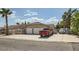 Single-story home with a two-car garage and a spacious driveway, with a red truck parked in front at 5775 W Desert Inn Rd, Las Vegas, NV 89146