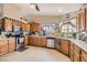 Traditional kitchen with stainless steel appliances, tile flooring, and oak cabinets at 5775 W Desert Inn Rd, Las Vegas, NV 89146