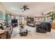 Open-concept living room with large windows, custom window coverings, and comfortable leather furniture at 5775 W Desert Inn Rd, Las Vegas, NV 89146