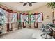Bright home office with large windows, custom window coverings and neutral carpet flooring at 5775 W Desert Inn Rd, Las Vegas, NV 89146