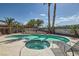 This inviting pool features a connected spa and a tanning deck; all surrounded by mature landscaping at 5775 W Desert Inn Rd, Las Vegas, NV 89146