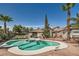 This beautiful pool area includes a spa, a deck, lush landscaping, and mature palm trees at 5775 W Desert Inn Rd, Las Vegas, NV 89146