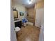 Bathroom featuring tile shower with seat, grab bars, and roll-under sink at 5820 W Desert Inn Rd, Las Vegas, NV 89146